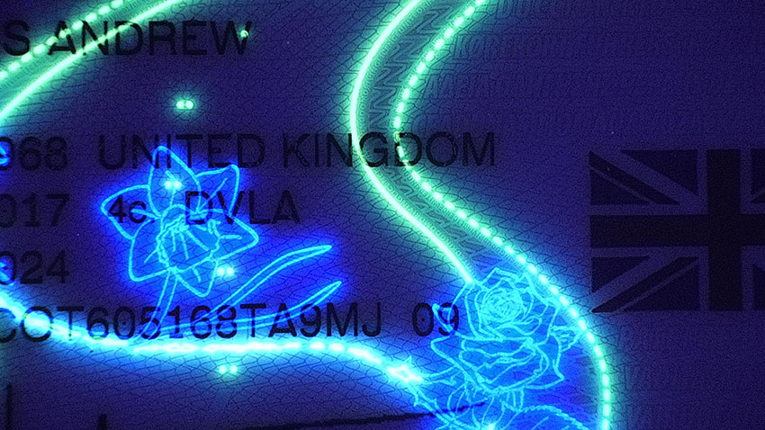 British Driving License fluorescing to reveal security features.
